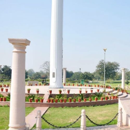 Tall national flag mast at Central Park Jaipur with open green surroundings